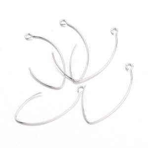 May include: Five silver jump rings, each with a circular shape and a small opening at the top. The rings are arranged in a loose pile.