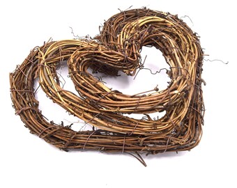 May include: A brown twig wreath shaped like a heart. The wreath is made of natural twigs and is perfect for decorating for Valentine's Day or other special occasions.