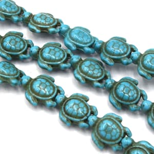 May include: A strand of turquoise blue turtle beads. The beads are made of a smooth, polished stone and have a realistic turtle design.