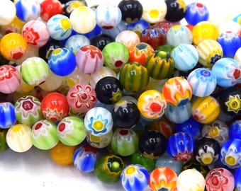May include: A collection of colorful glass beads in various sizes and designs. The beads feature a mix of colors, including red, blue, yellow, green, and white, with intricate floral and geometric patterns. These beads are ideal for jewelry making and crafting.