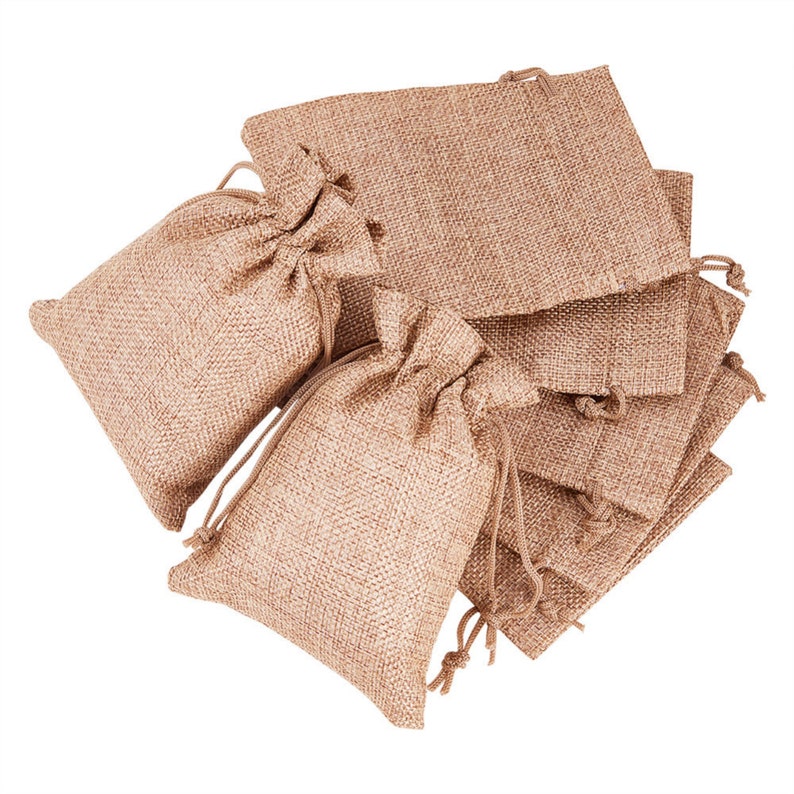 May include: A stack of brown burlap drawstring bags. The bags are made of a natural, woven fabric and have a rustic look.