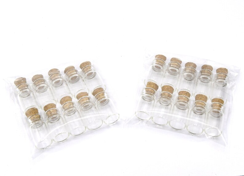 May include: Two packages of clear glass bottles with cork stoppers. Each package contains 12 bottles.