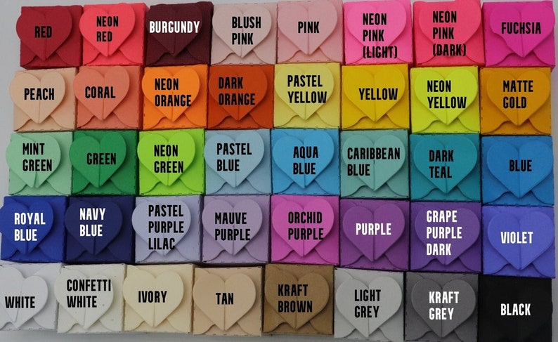 May include: A collection of small, heart-shaped boxes in various colors, including red, pink, yellow, blue, and green. Each box has a label with the color name, such as "Red," "Pink," and "Green." The boxes are arranged in a grid pattern.