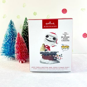 May include: A Hallmark Keepsake Christmas tree ornament featuring Jack Skellington and Zero from Tim Burton's The Nightmare Before Christmas. The ornament is a Funko Pop! figure of Jack Skellington dressed as Santa Claus, climbing up a chimney with Zero peeking out from behind him.