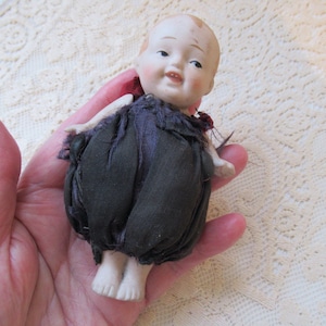 All bisque Nippon baby doll. 4 3/8 inches. Before 1921.