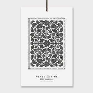 May include: A white 2026 calendar with a black floral design and the text "VERSE AND VINE". The calendar has a leather cord for hanging. The floral design includes flowers and leaves, with text around the border.