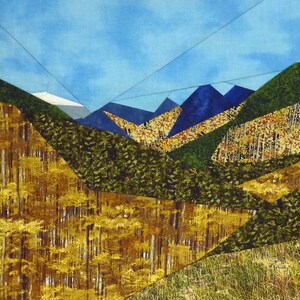 May include: A quilt depicting a mountain range with a blue sky and a variety of green and yellow foliage.