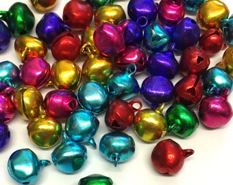 May include: A collection of colourful metal jingle bells. The bells are in various shades of red, green, blue, gold, and silver. They are perfect for adding a festive touch to crafts, decorations, and gifts.