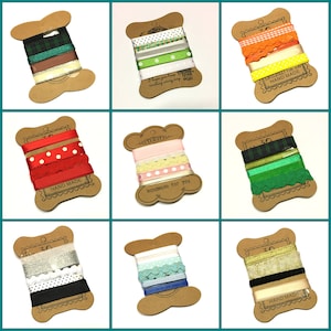 May include: Nine spools of ribbon, each wrapped in brown paper with a label. The ribbons are in various colours and patterns, including red, green, white, black, and gold. The labels have the text "HAND MADE" and "Handmade for you".