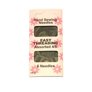 May include: A pink and white package of 6 assorted hand sewing needles. The package says "Easy Threading Assorted 4/8" and "Hand Sewing Needles".