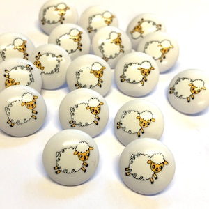 May include: A selection of white ceramic cabinet knobs. Each knob showcases a cartoon sheep design with a fluffy white body, yellow face, and black legs. The sheep are shown in a running pose, adding a playful touch to the hardware.