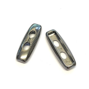 May include: Two silver-toned toggle clasps, one with two holes and the other with three holes.
