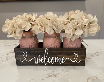Mason Jar Centerpiece. Wood box with three pint size mason jars and flowers