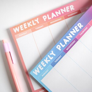 May include: Two weekly planners, one with a pink and orange gradient and the other with a blue and purple gradient. Both planners have the text "Weekly Planner" in white, bold letters. The days of the week are listed across the top of each planner.