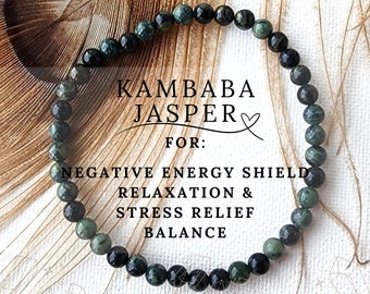 May include: A green and black Kambaba Jasper bracelet with the text "Kambaba Jasper" and "For: Negative Energy Shield, Relaxation & Stress Relief, Balance".