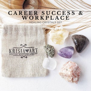May include: A set of six crystals in a small burlap bag. The crystals are clear, yellow, purple, brown, green, and pink. The bag has the text "Krisja Art" printed on it. The text "Career Success & Workplace Healing Crystals Set" is printed above the bag.