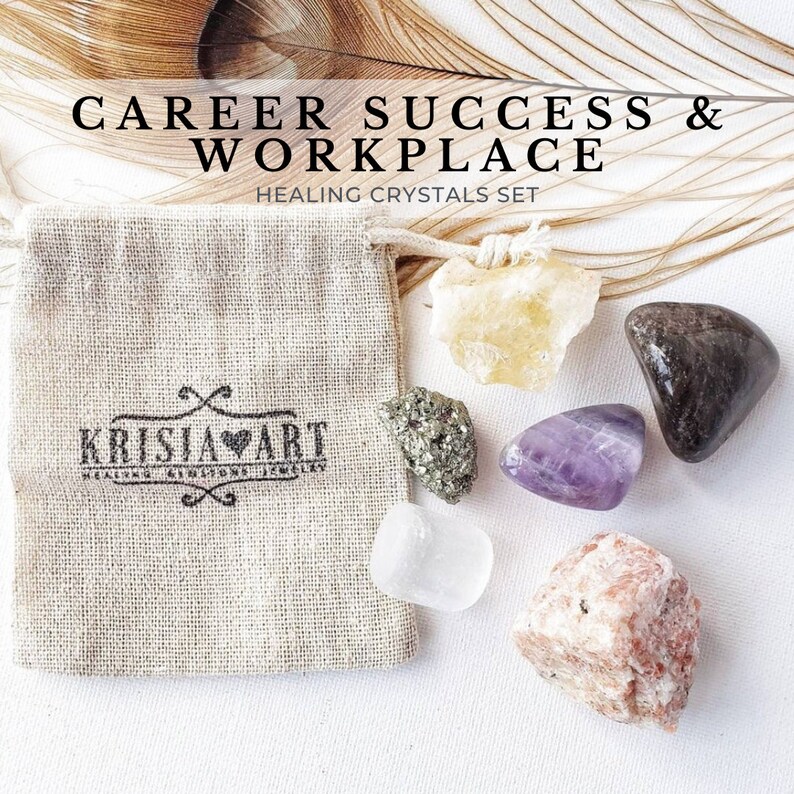 May include: A set of six crystals in a small burlap bag. The crystals are clear, yellow, purple, brown, green, and pink. The bag has the text "Krisja Art" printed on it. The text "Career Success & Workplace Healing Crystals Set" is printed above the bag.