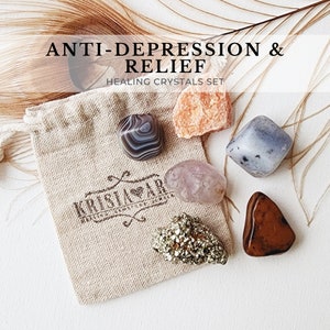 May include: A set of six healing crystals in a small burlap bag. The crystals are amethyst, rose quartz, clear quartz, carnelian, pyrite, and a grey crystal. The bag has the text "Kristal Air" printed on it. The crystals are for anti-depression and relief.