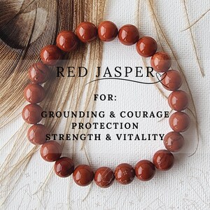 May include: Red jasper bracelet with 14 beads. The bracelet is made of natural red jasper stones. The text on the image reads "RED JASPER FOR: GROUNDING & COURAGE PROTECTION STRENGTH & VITALITY".