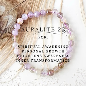 May include: Auralite 23 beaded bracelet with purple, clear, and brown stones. The text on the image says "Spiritual Awakening, Personal Growth, Heightens Awareness, Inner Transformation."