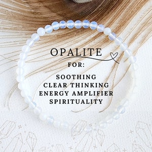 May include: A white opalite bracelet with the text "OPALITE FOR: SOOTHING CLEAR THINKING ENERGY AMPLIFIER SPIRITUALITY" on a white background.