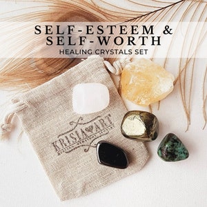 May include: A set of five healing crystals in a small white drawstring bag. The crystals are: clear quartz, citrine, pyrite, black obsidian, and turquoise. The bag has a label that says "KRISIA ART". The set is labelled "SELF-ESTEEM & SELF-WORTH HEALING CRYSTALS SET".