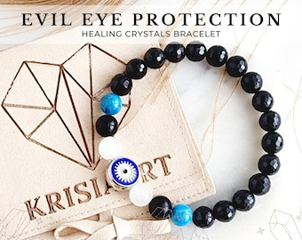 May include: Black onyx beaded bracelet with a blue and white evil eye charm. The bracelet is on a beige suede pouch with the text "KRISIA RT" printed on it.  Evil Eye Protection Healing Crystals Bracelet.