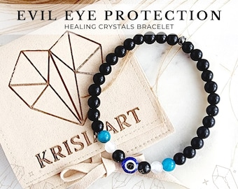 May include: Black beaded bracelet with a blue evil eye charm, white and turquoise beads, and the words "KRISIA ART" on a beige leather pouch.