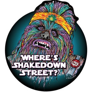 May include: A colorful illustration of a Wookiee with a headband and the text "Where's Shakedown Street?" and a red circle with the text "Wook" in white.
