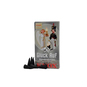 May include: A box of black incense cones with a white angel and a soldier holding a lantern on the front. The box says "Glück Auf" Räucherkerzen incense cones Knox.