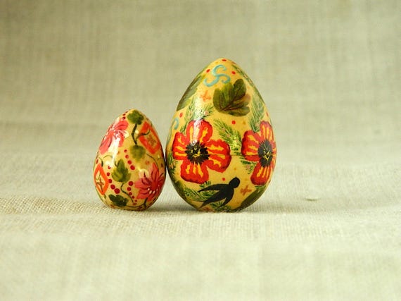 Individually hand-painted wooden eggs with intricate folk-art motifs — the kind of collectible object you pass down, not throw away.
