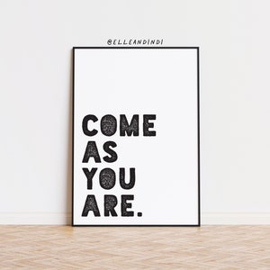 May include: Black and white typography print with the text "COME AS YOU ARE." in a black frame against a white wall.