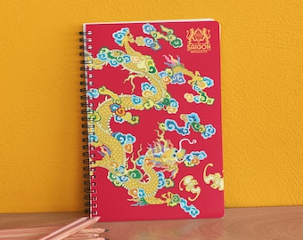 May include: A red spiral notebook with a gold dragon design and the text "SAIGON AUGUSTA" on the cover.