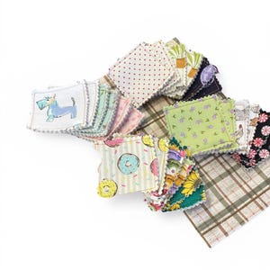 May include: A collection of small, square fabric patches with various patterns. Designs include polka dots, plaid, floral, and cartoon illustrations of a dog and donuts. Each patch has a scalloped edge.