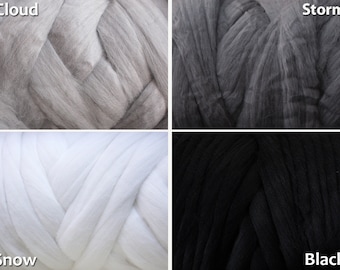 May include: Four skeins of yarn in different shades of gray. The skeins are labeled "Cloud", "Storm", "Snow", and "Black".