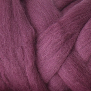 May include: A close-up of a braided bundle of soft, mauve-colored wool yarn.
