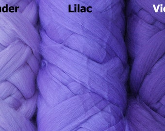 May include: Three skeins of yarn in shades of lavender, lilac, and violet. The yarn is braided and has a soft, fluffy texture.