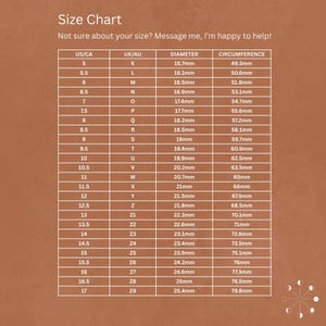 May include: A size chart for rings, with US/CA and UK/AU sizes, diameter in millimeters, and circumference in millimeters. The chart includes sizes from 5 to 17, with corresponding measurements. The text "Size Chart" is at the top.