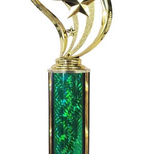 May include: Gold trophy with a green base and a red plaque that says "Family Christmas Eve 2024 WINNER". The top of the trophy has a gold star design and a white circle with the words "Ugly Christmas Sweater" in red.