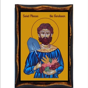 May include: A wooden framed icon of Saint Phocas the Gardener. The icon depicts a bearded man in a blue robe holding a shovel and a basket of fruit. The background is a yellow-gold color.
