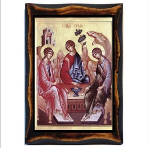 May include: A religious icon depicting the Holy Trinity, three figures in a seated pose, with a golden background and a wooden frame.
