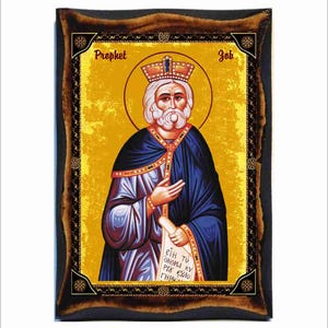May include: A religious icon depicting the Prophet Job, a bearded man wearing a crown and blue robes, holding a scroll with Greek text. The icon has a gold background and a dark wood frame.