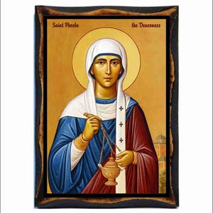 May include: An icon of Saint Phoebe, the Deaconess, in a dark wooden frame. The image depicts a woman in blue and burgundy robes, holding a golden censer. The text "Saint Phoebe" and "the Deaconess" are visible at the top of the image, against a gold background.