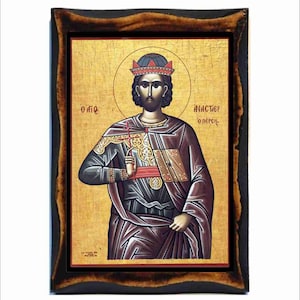 May include: Byzantine icon of a king wearing a crown and holding a scepter. The icon is painted on a wooden panel and has a gold background. The text on the icon reads "Ο ΑΓΙΟΣ Ο ΠΕΡΣΗΣ".