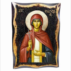 May include: An icon depicting a religious figure holding a cross. The figure is dressed in red and black robes, with a gold halo and gold accents. The background is dark with a textured border, and the text "ST. PHOEB E" is visible.