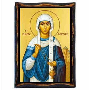 May include: Icon of St. Phoebe the Deaconess, featuring a woman in a white head covering and blue robes, holding a censer and chain. The image has a gold background with text that reads "ST PHOEBE DEACONESS" and is framed in a dark wood.