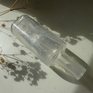 Victorian clear glass bottle, old apothecary bottle, antique medicine or ointment bottle. Bud vase, perfume bottle. Pharmacy, chemist bottle