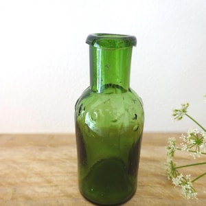 Victorian green glass homeopathic apothecary bottle, embossed Leath & Ross, antique small green homeopathy pill bottle, circa 1855 film prop
