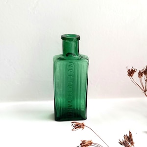 Antique emerald green Not To Be Taken poison bottle, rectangular green 1 oz ribbed bottle. Victorian / Edwardian chemist bottle, bud vase