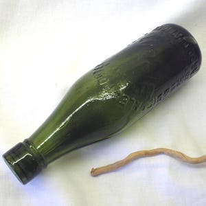 Antique green beer bottle. Victorian / Edwardian Birbot CS & Co Ltd collectible bottle. Birmingham Ale Porter Bottlers 1892-1913. Bud vase